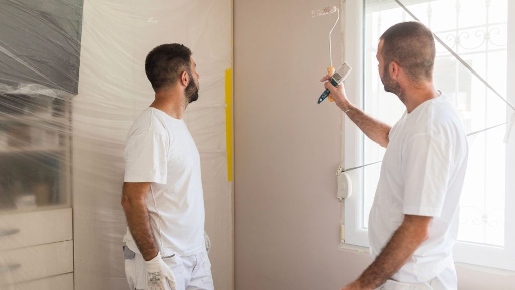 handymen making house remodeling plan and talking about it