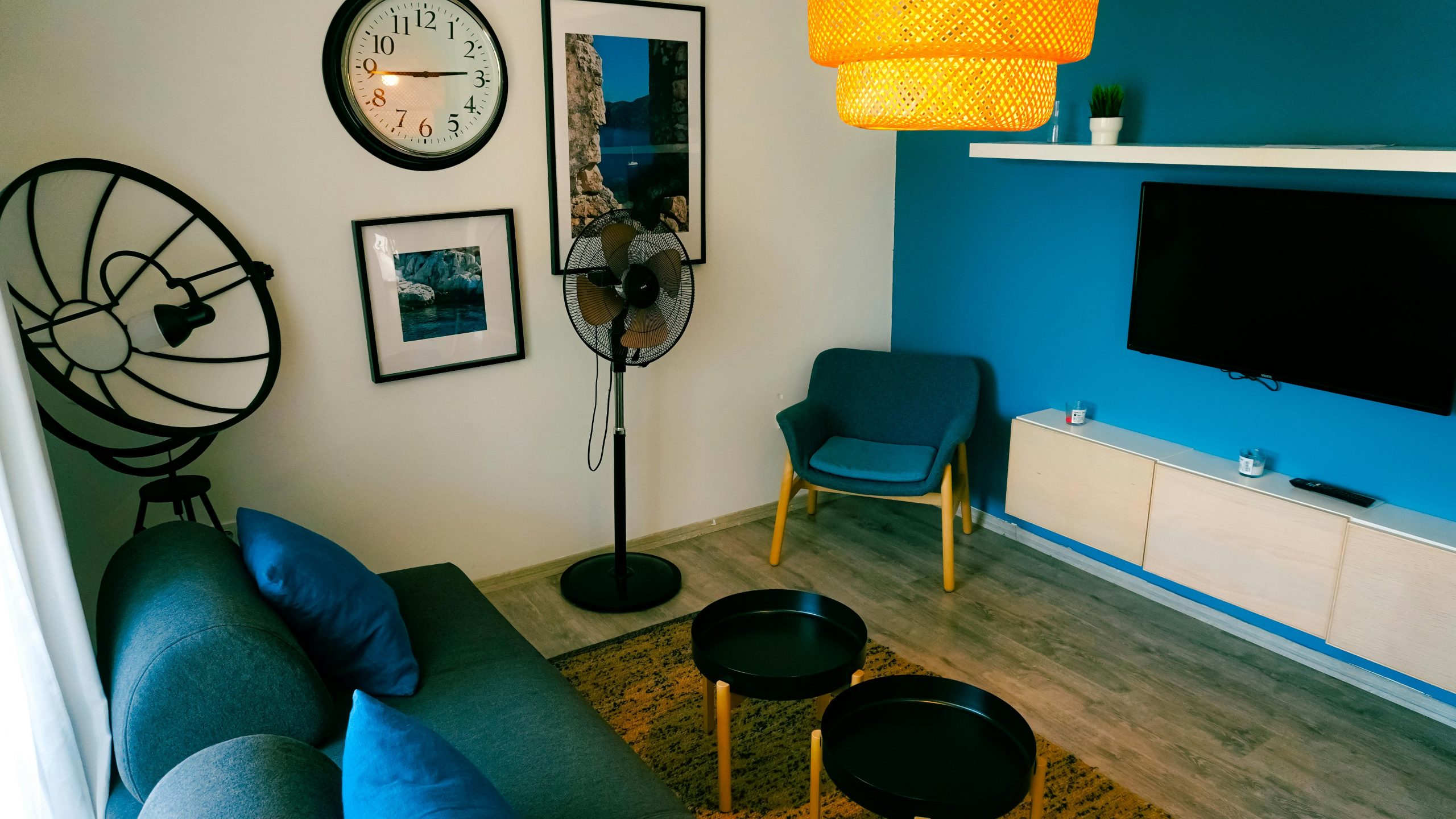 Stylish living room with blue accents, wall art, and modern furniture.