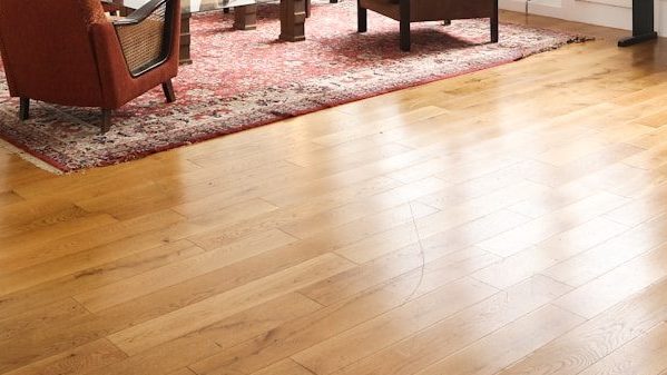 living room with brown wooden parquet floor and white wall